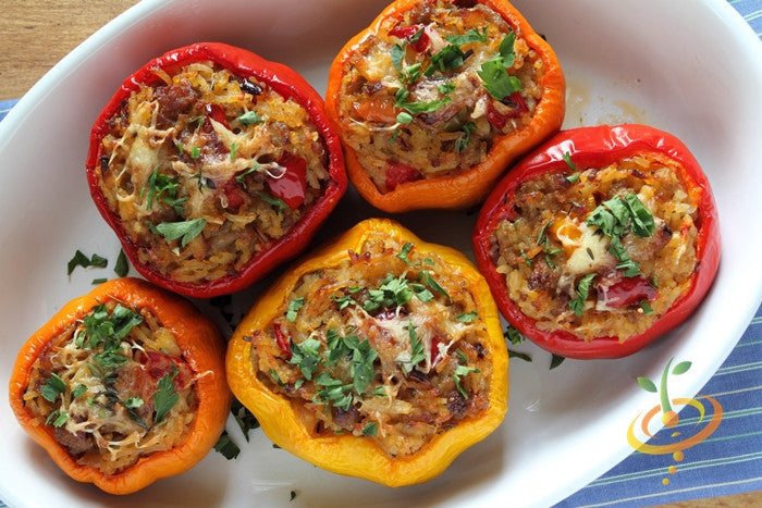 Baked stuffed California Wonder peppers with rice, cheese, and herbs in a white dish